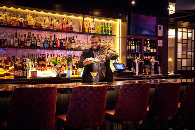 A bartender pouring drinks