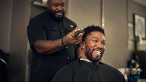 A barber provides service to a main in a salon