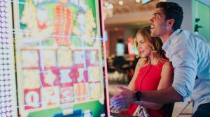 Two people playing slots together
