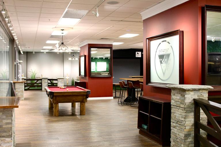 Modern recreational area with a pool table and seating.