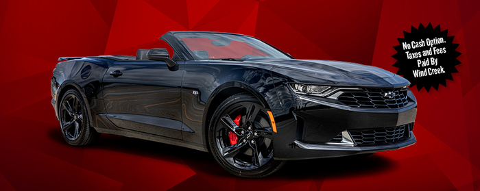 A black Camaro 3LT Convertible with its top down in front of a decorative red background. Next to the car is a text that reads, "No Cash Option. Taxes and Fees Paid By Wind Creek."