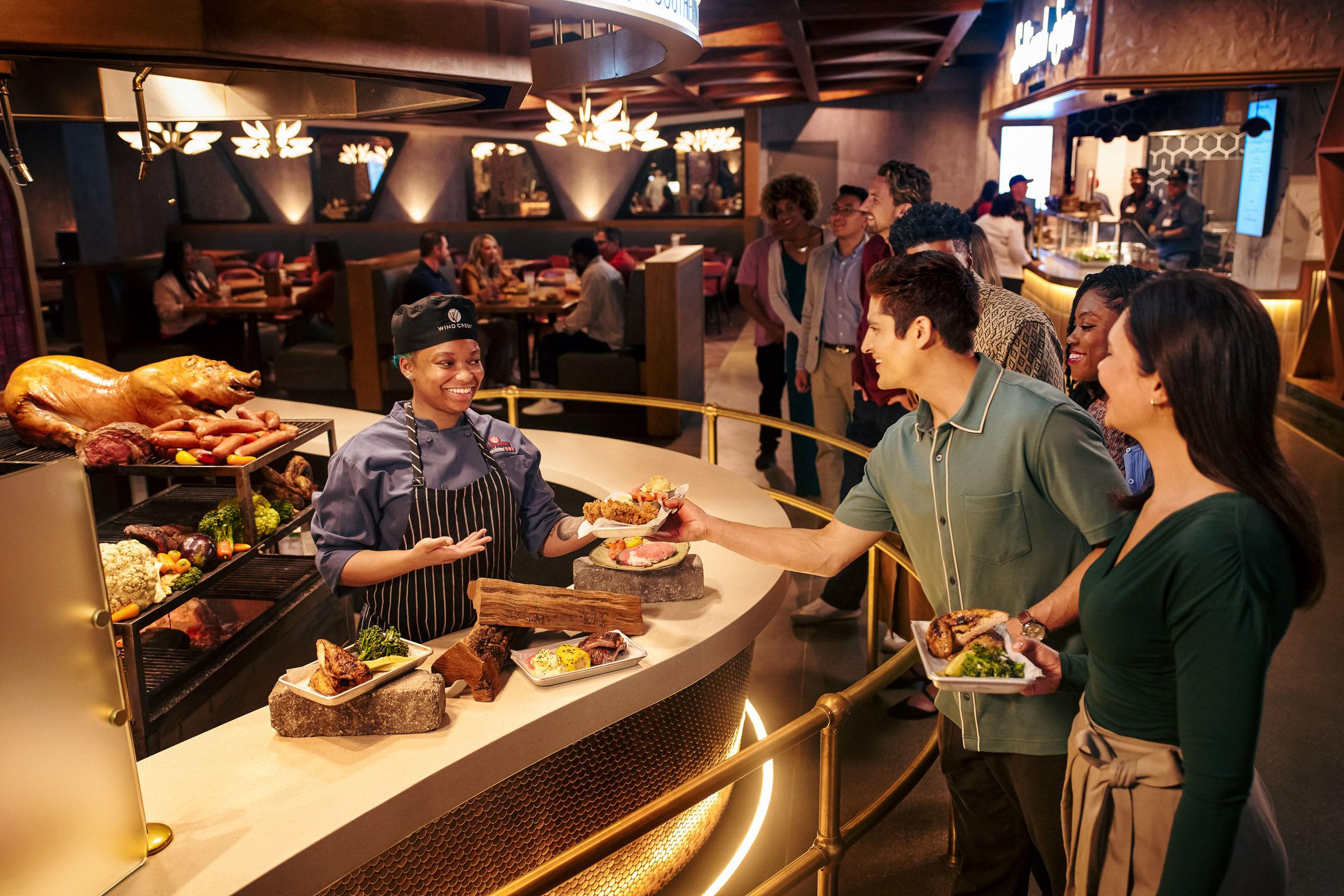 People being served at a fancy buffet.