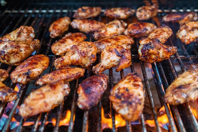 Chicken wings cooking on a grill