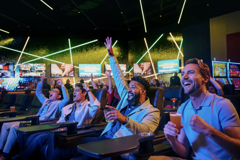group of men cheering at a sports game in Sportsbook Lounge
