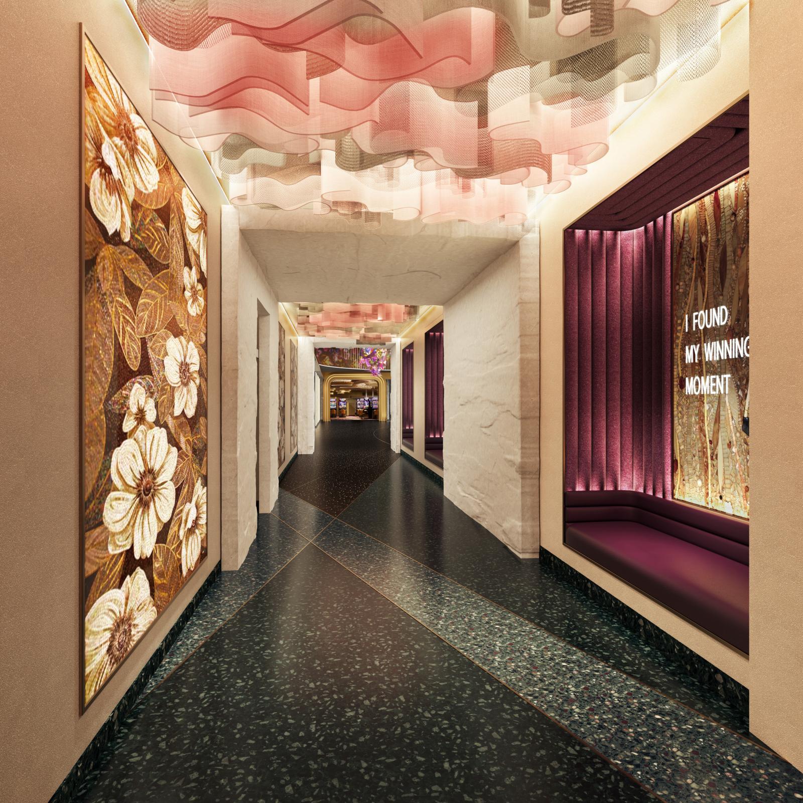 View of a hallway with soft, custom lighting, botanical art, and a magenta booth set into the wall for taking selfies