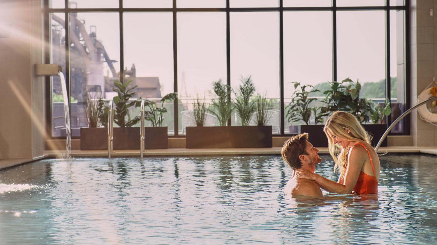 A couple enjoying the indoor pool at Wind Creek Bethlehem.