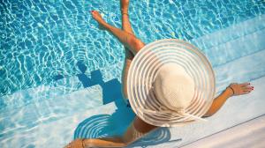 A woman in a sunhat lounging in the pool