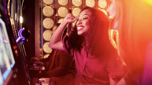 two woman playing slot machine hitting jackpot at wind creek chicago southland